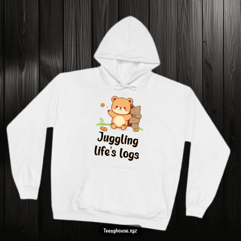 Funny Hoodie: Tiny bear juggling tiny logs near a small wooden door, offering cozy and humorous comfort.